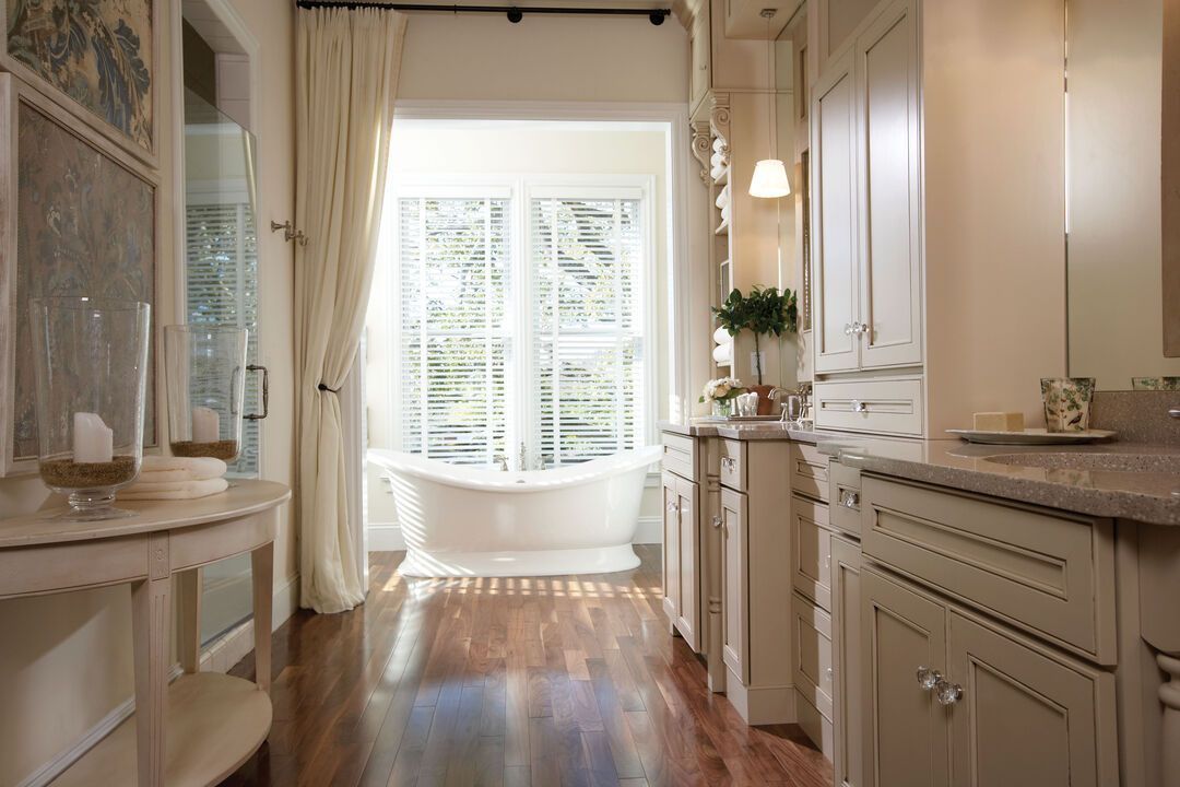 Spa style bathroom with a freestanding soaking tub, marble tiled shower and large windows