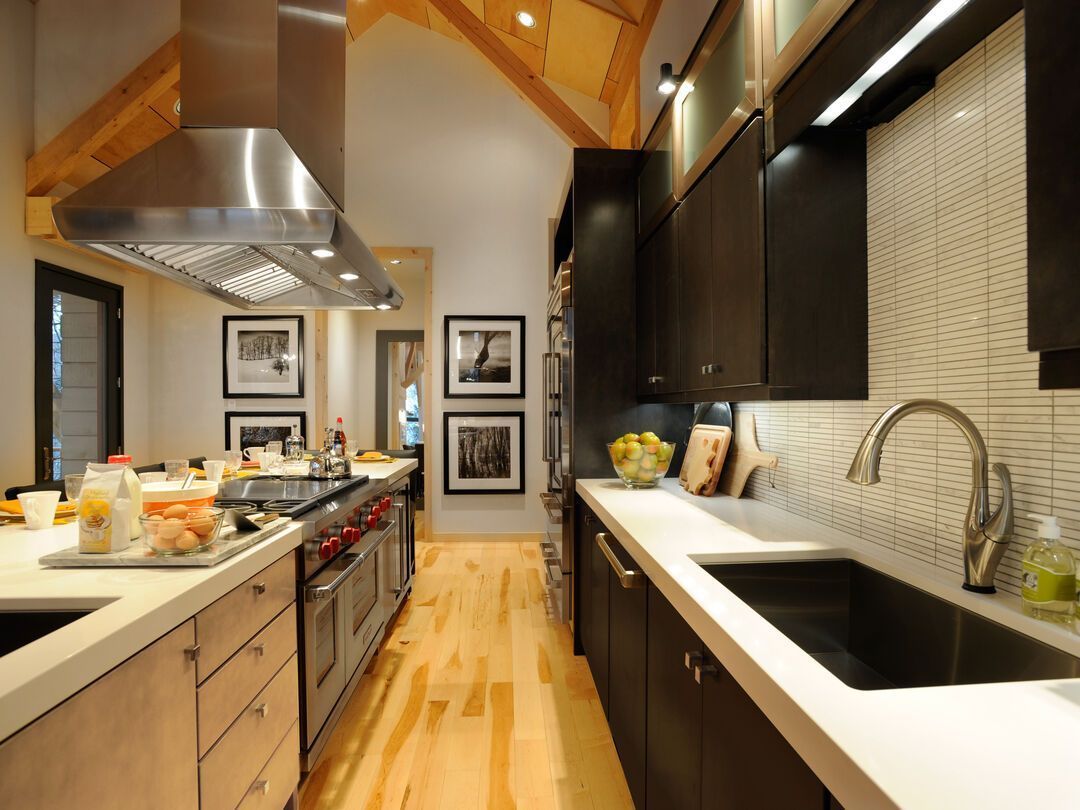 Kitchen with wide plank hardwood flooring running through to the adjoining room