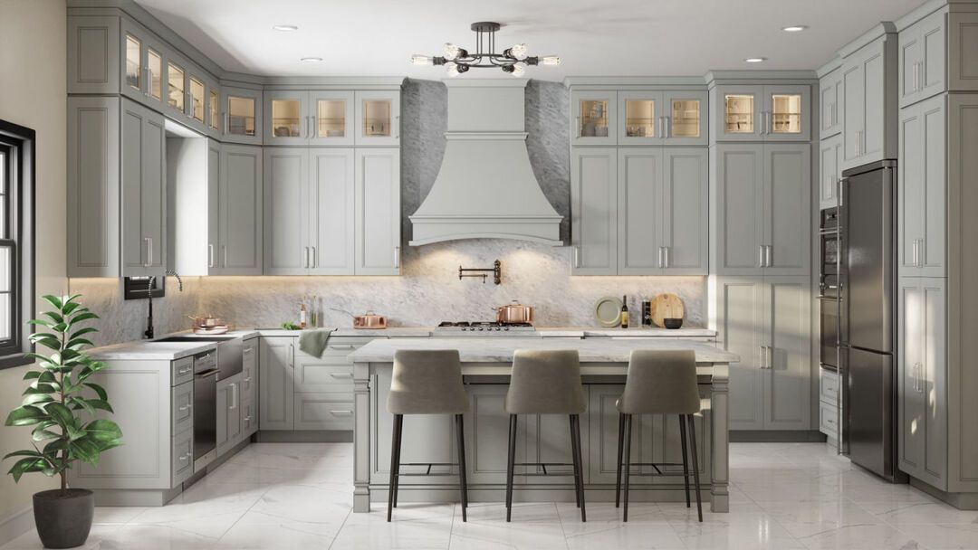 Remodeled kitchen with sage green cabinetry, a marble range hood and a central island with seating